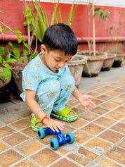 A child wearing unisex topical print nightwear for kids and playing with a toy