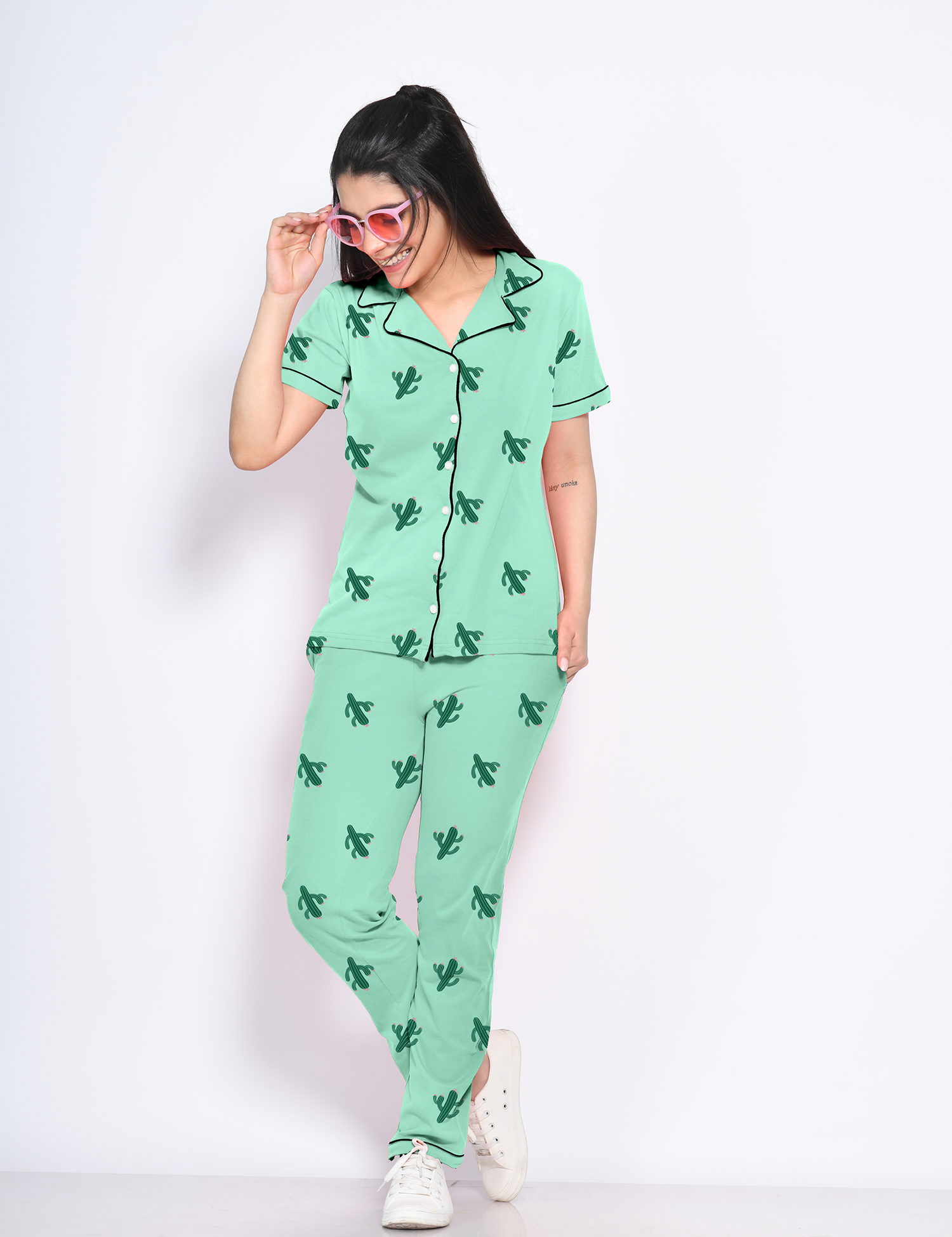 A young lady flaunting green colour cactus print nightwear pyjama set by NapStory