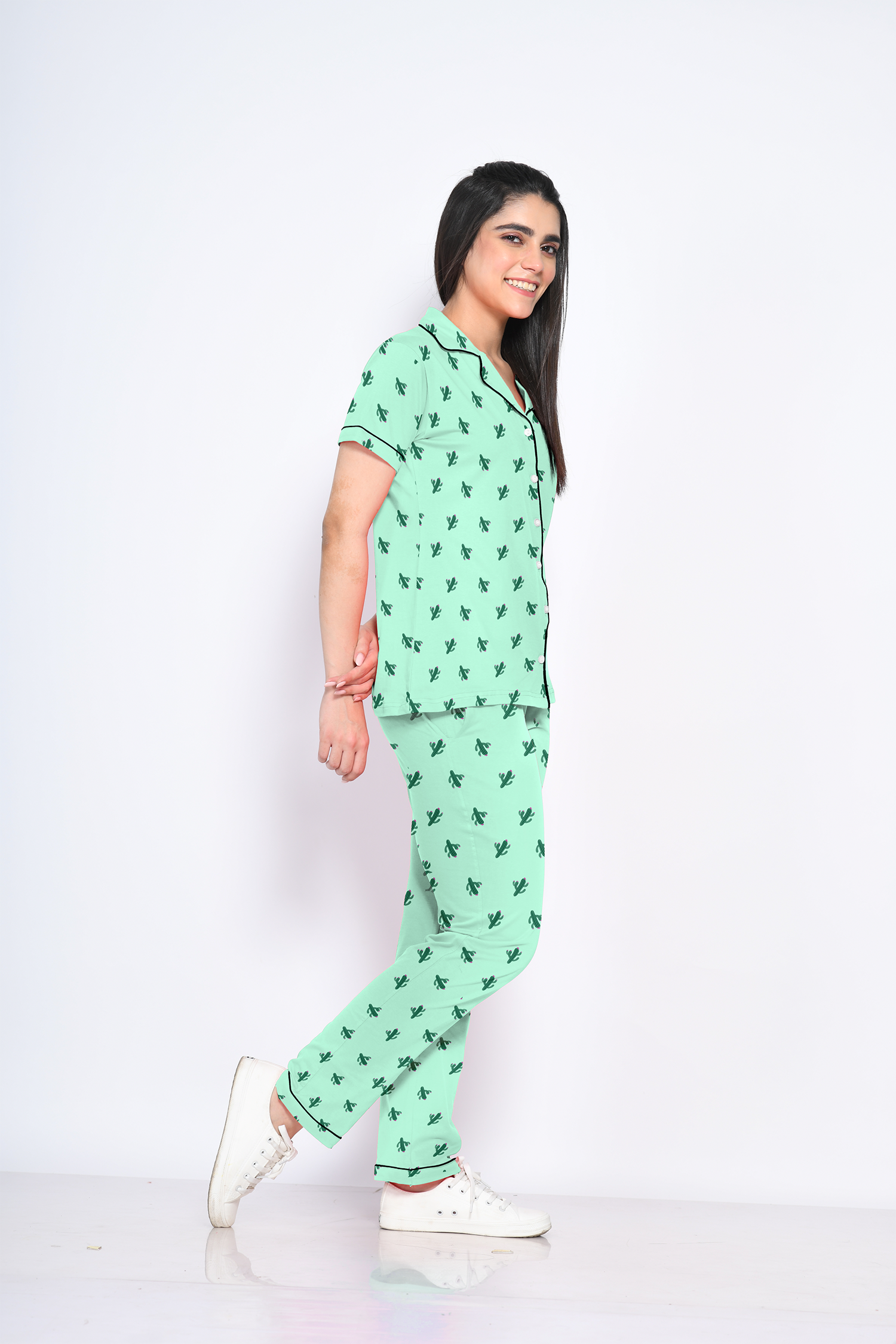 A young lady showing side view of 100% cotton green colour cactus print nightwear pyjama set by NapStory