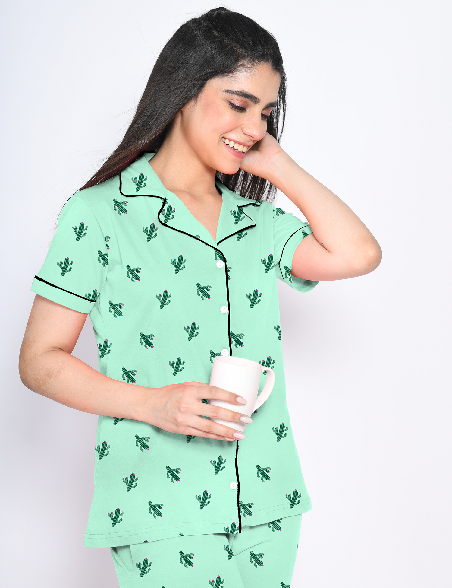 A young lady in 100% cotton green colour cactus print nightwear pyjama set by NapStory