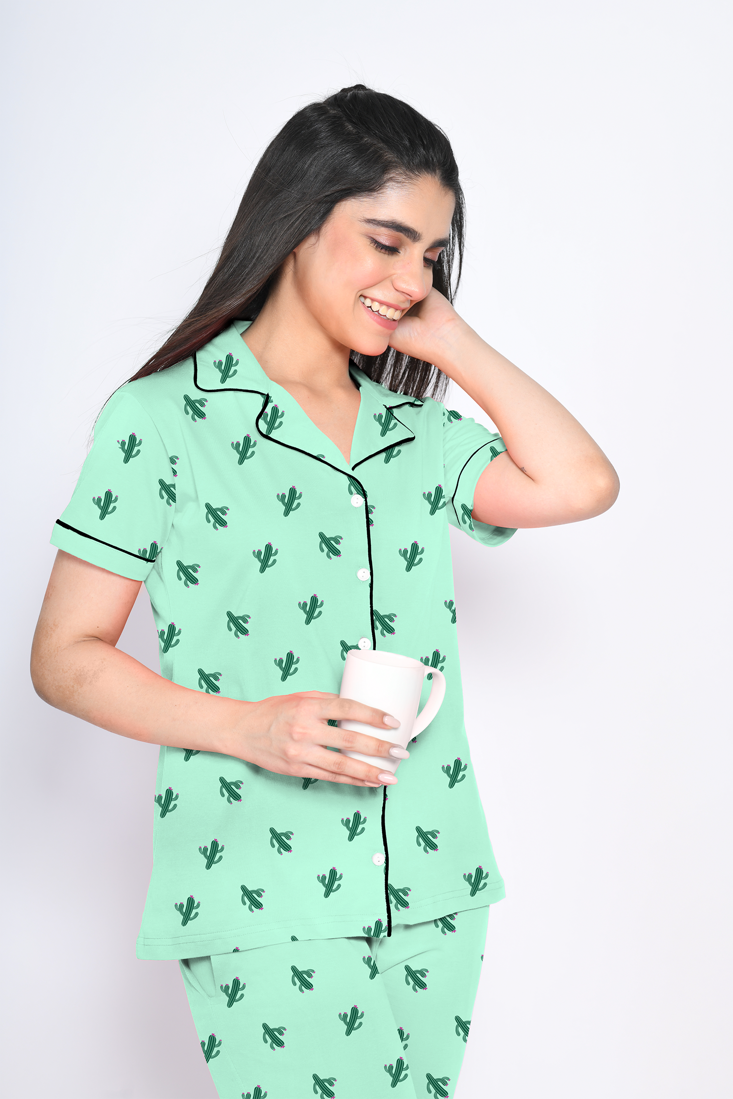 A young lady in 100% cotton green colour cactus print nightwear pyjama set by NapStory