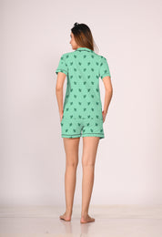 A young lady showing back view of green colour cactus print nightwear shorts set  for women by NapSotry