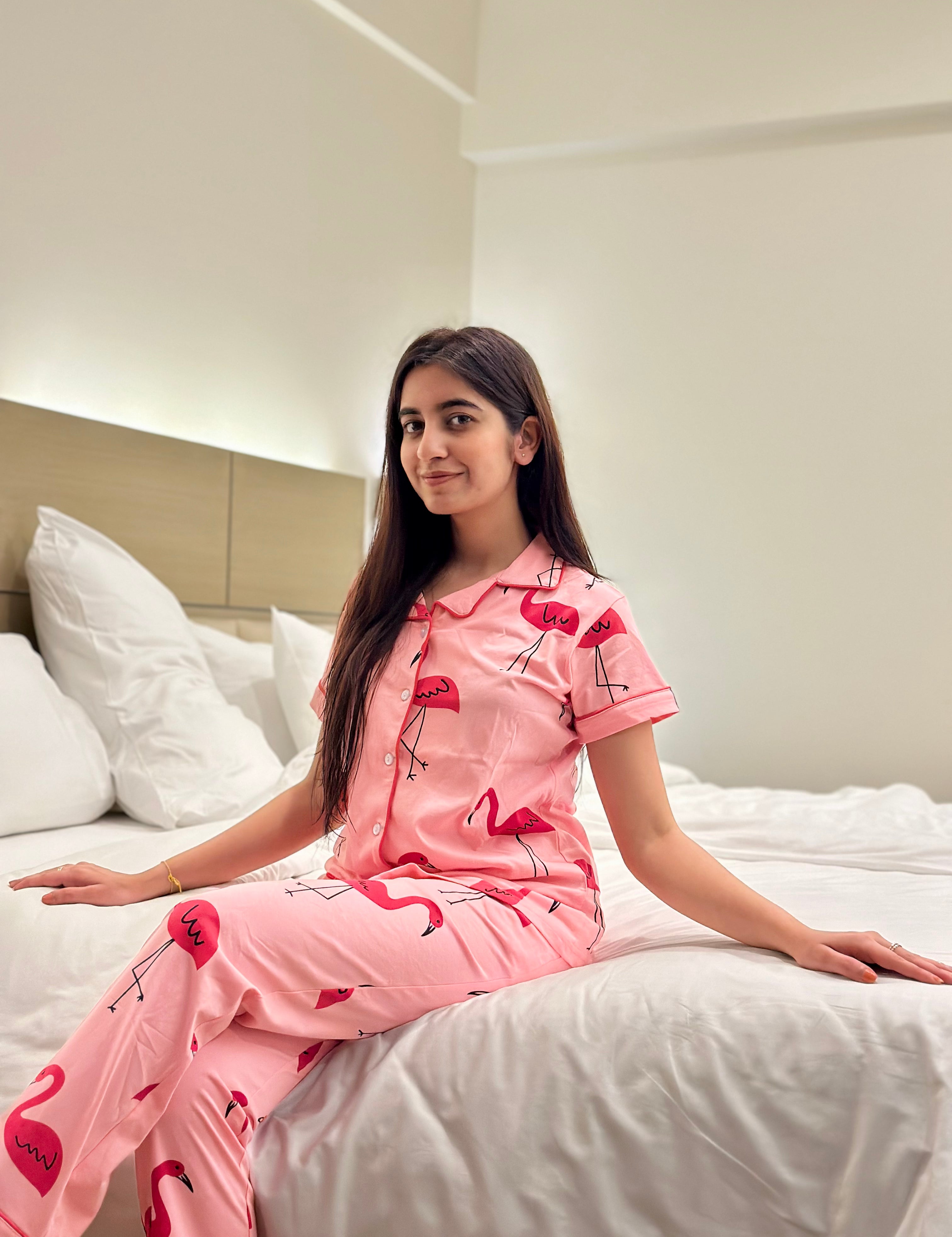 Woman wearing Flamingo Print Pyjama Set sitting on bed