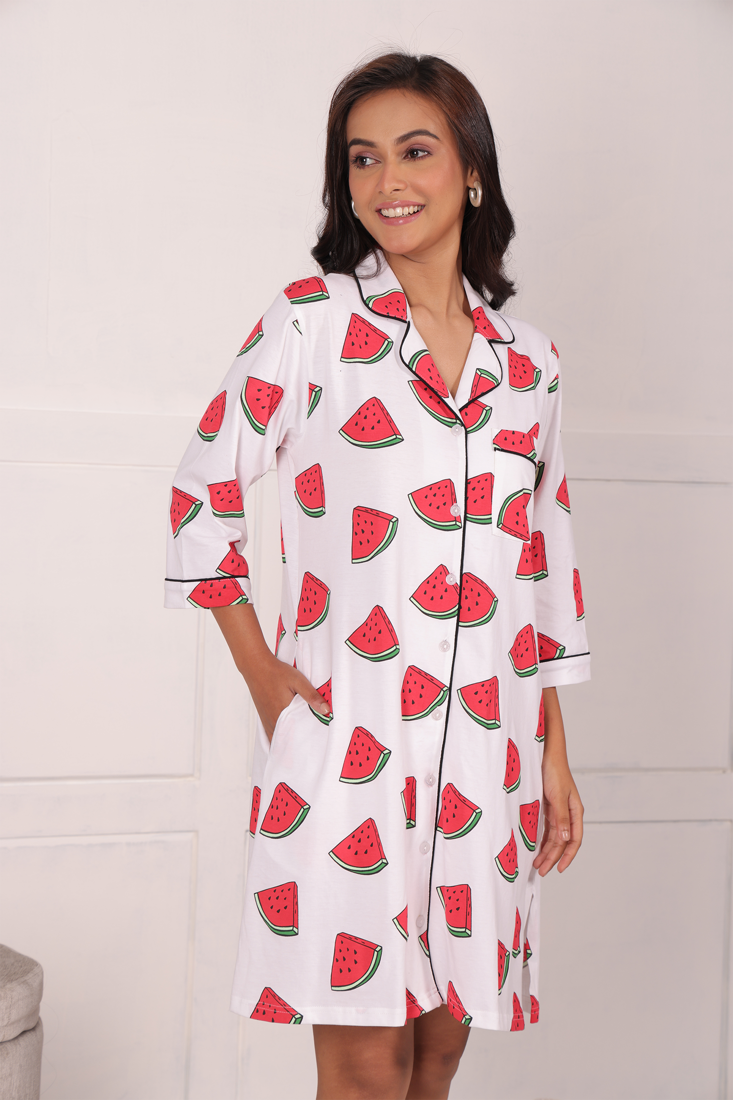 A girl in hands in pocket pose wearing watermelon print shorts set nightwear by NapStory