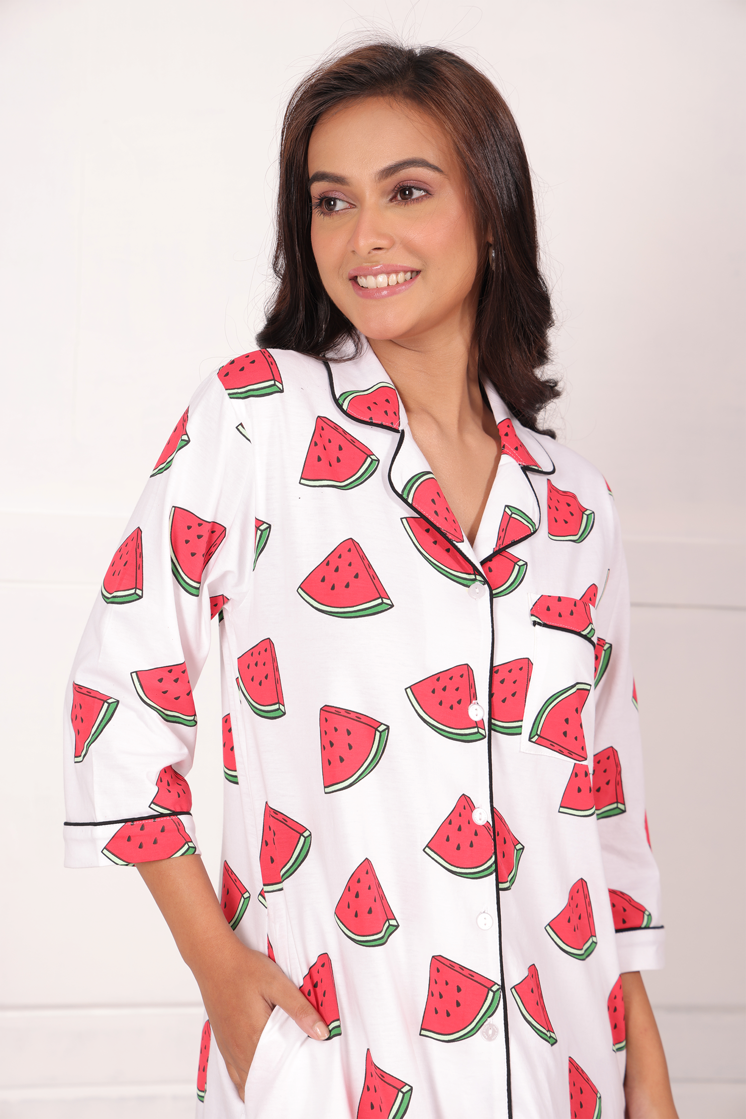 A young girl wearing watermelon print shorts set nightwear by NapStory