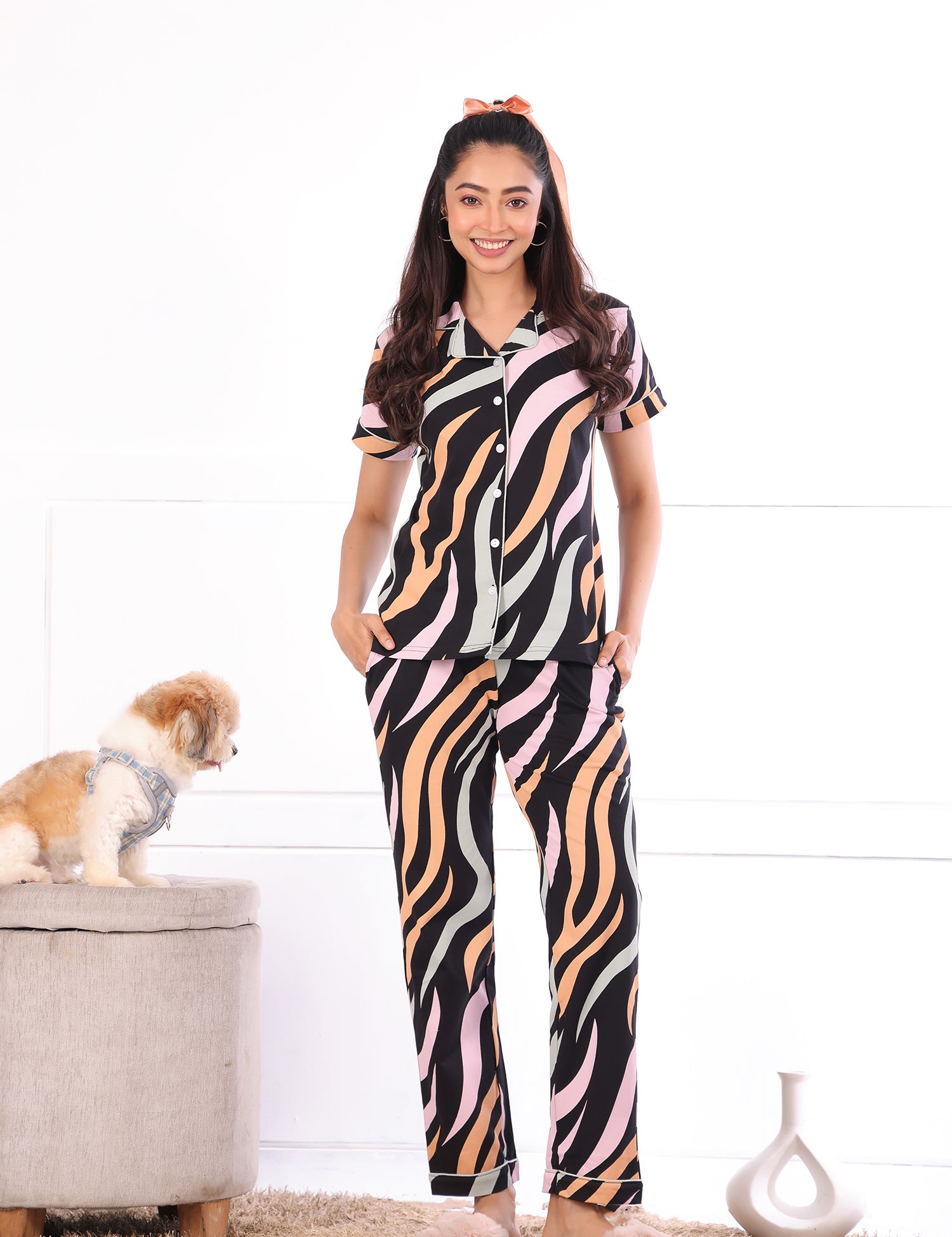 A woman with a dog in a different pose wearing  Dreamy Waves print nightwear pyjama set for women by NapStory