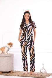 A woman with a dog in a different pose wearing  Dreamy Waves print nightwear pyjama set for women by NapStory