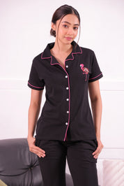 A young woman wearing flamingo embroidery premium pyjama set by NapStory