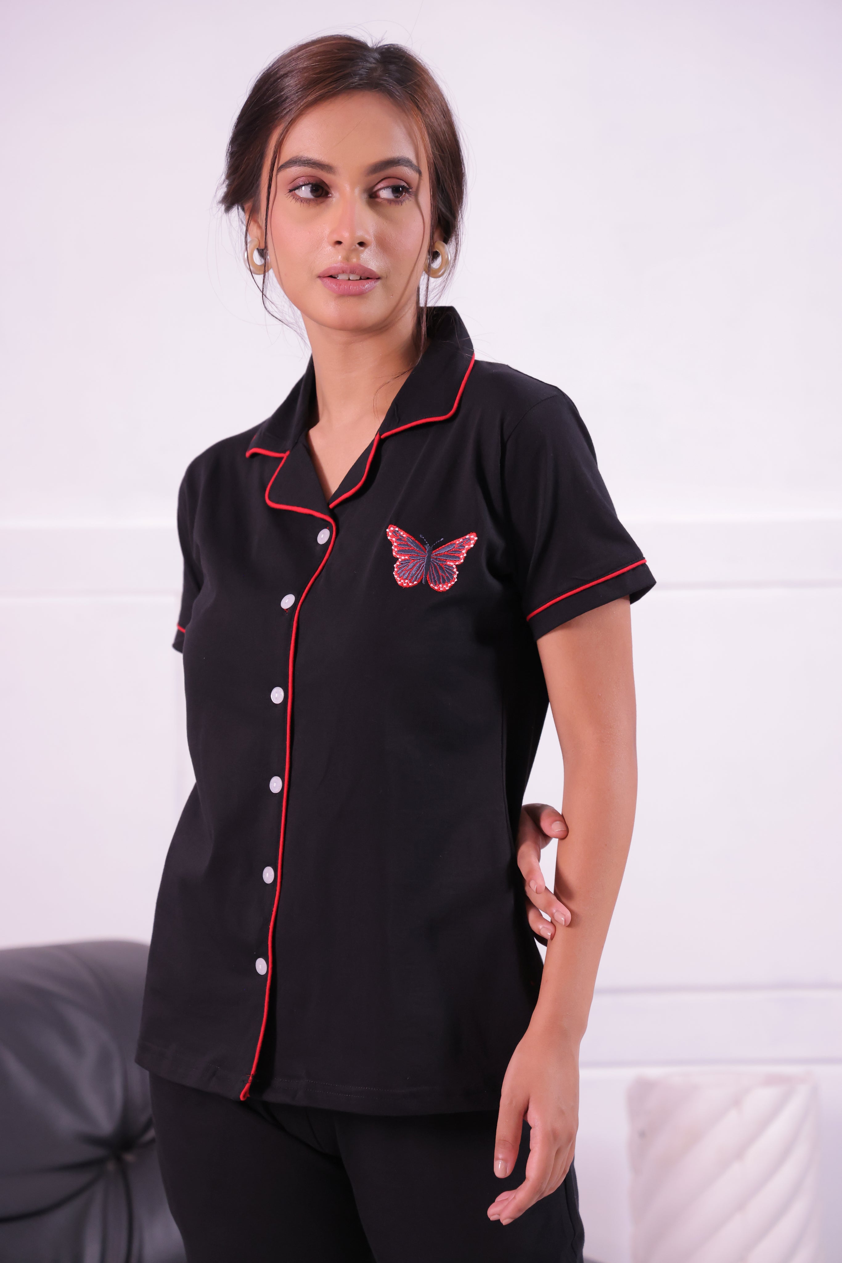 A young woman in Butterfly embroidered premium nightwear pyjama set by NapStory