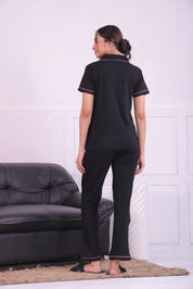 A lady showing back view of Feather embroidered premium nightwear pyjama set for women by NapStory