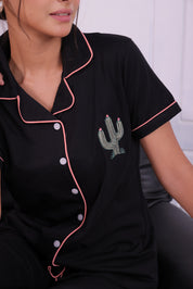 A young female in shirt of a Cactus embroidered premium nightwear shirt and pyjama set by NapStory