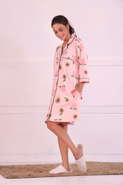 Young girl in a Pink Colour Peach Print Sleep Shirt nightwear by NapStory, walking playfully.