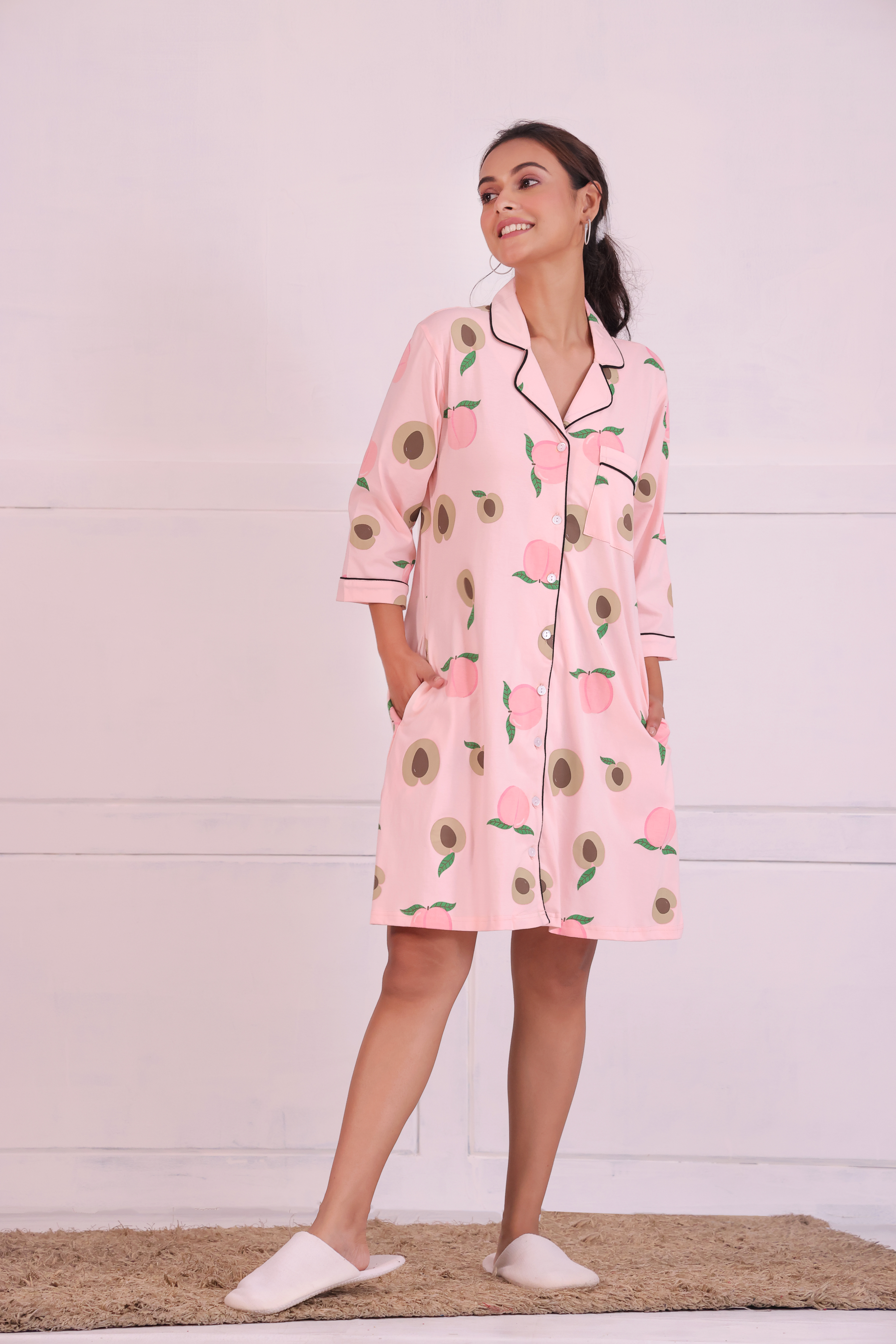 Young girl in a Peach Print Sleep Shirt nightwear by NapStory, standing confidently.