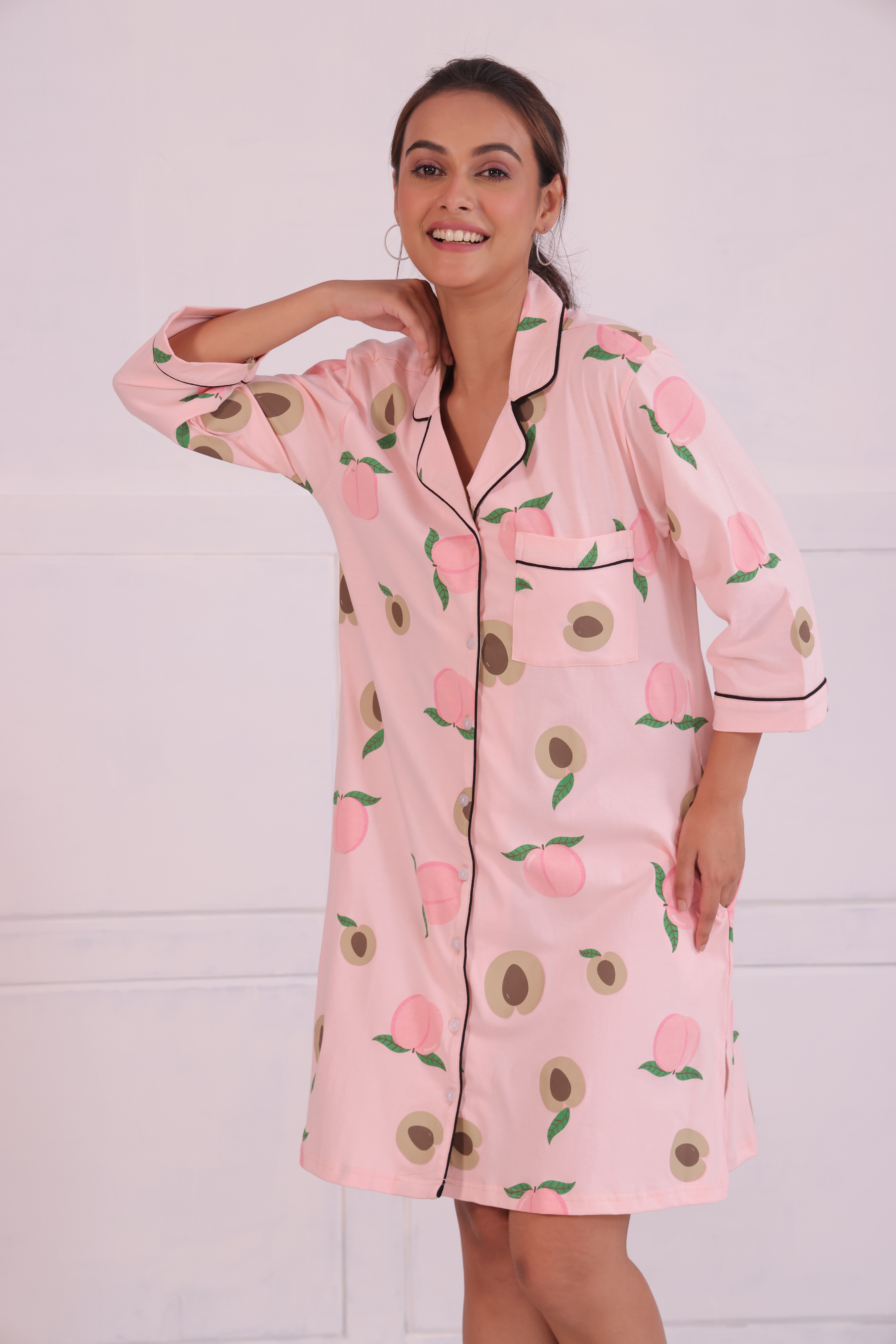 Young girl in a Pink Colour Peach Print Sleep Shirt nightwear by NapStory, smiling brightly.