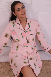 Young girl in a Pink Colour Peach Print Sleep Shirt nightwear by NapStory, sitting confidently.