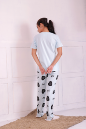 Back view of lady in stylish white colour bows and heart print nightwear t-shirt pyjama set.