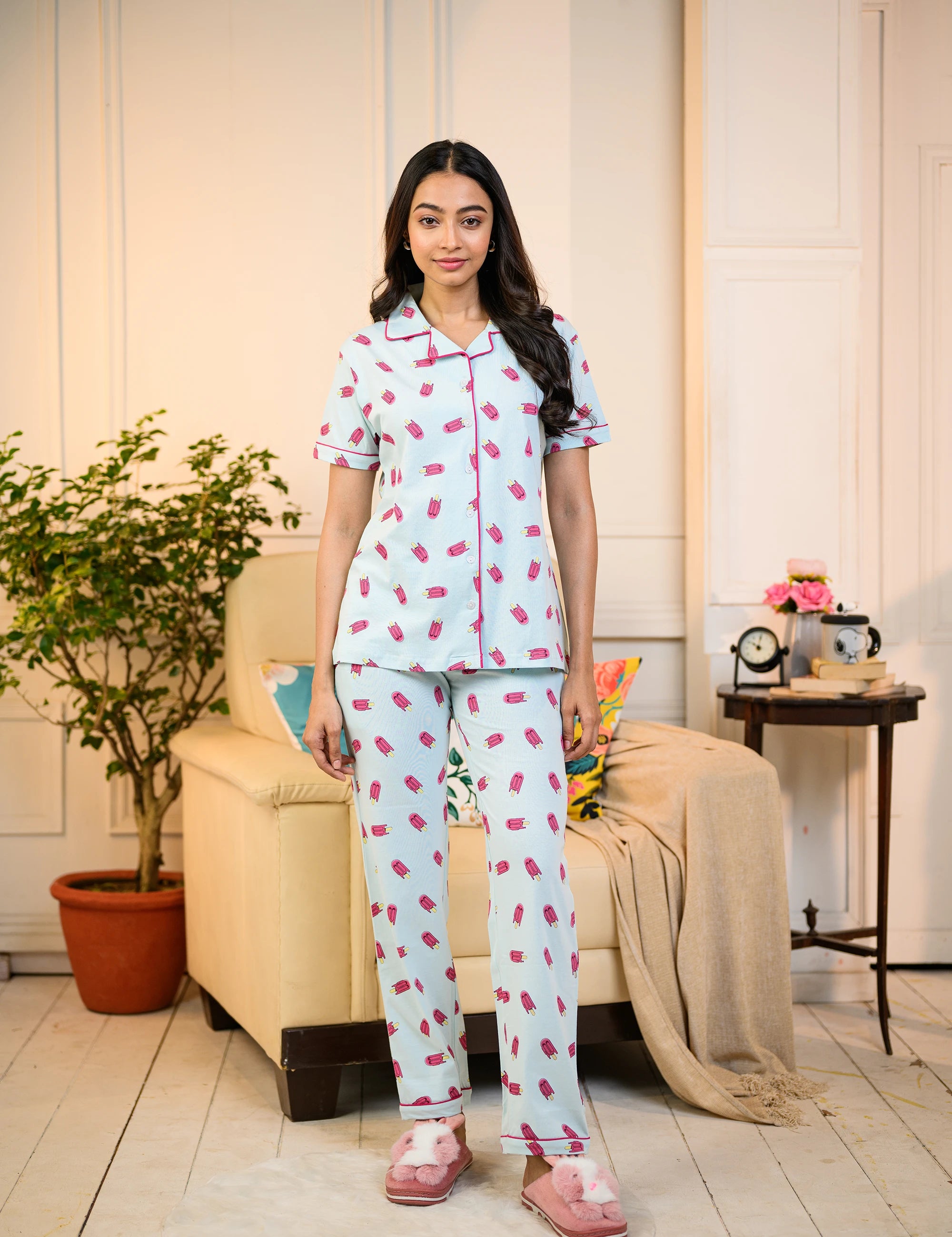 A woman stands confidently in the Popsicle Print Pyjama Set by NapStory, looking comfortable and stylish.