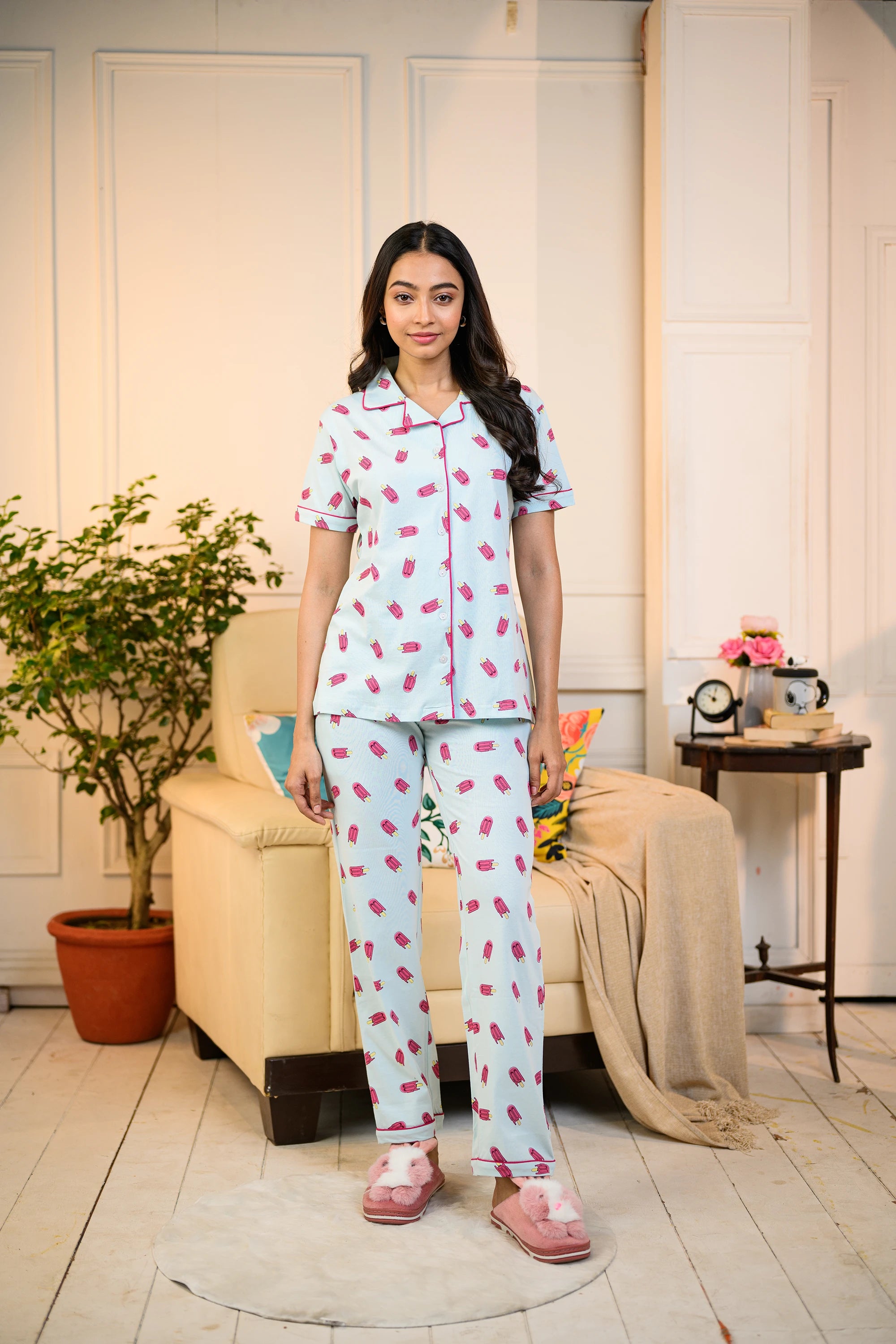 A woman stands confidently in the Popsicle Print Pyjama Set by NapStory, looking comfortable and stylish.