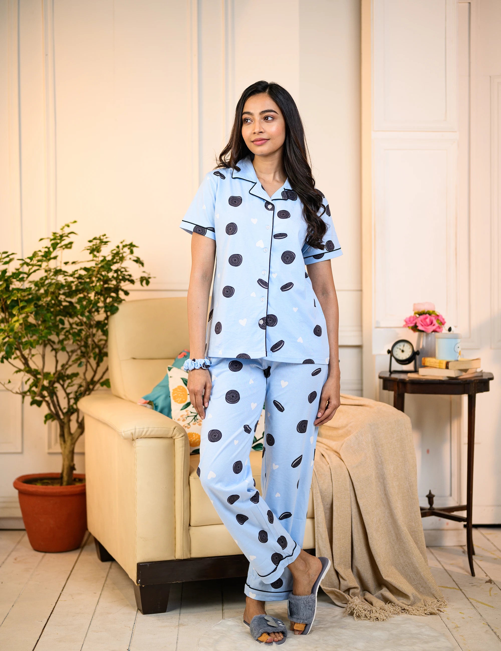 Woman standing in a blue Oreo Print Pyjama Set by NapStory, featuring playful cookie designs, styled for nightwear or lounging.