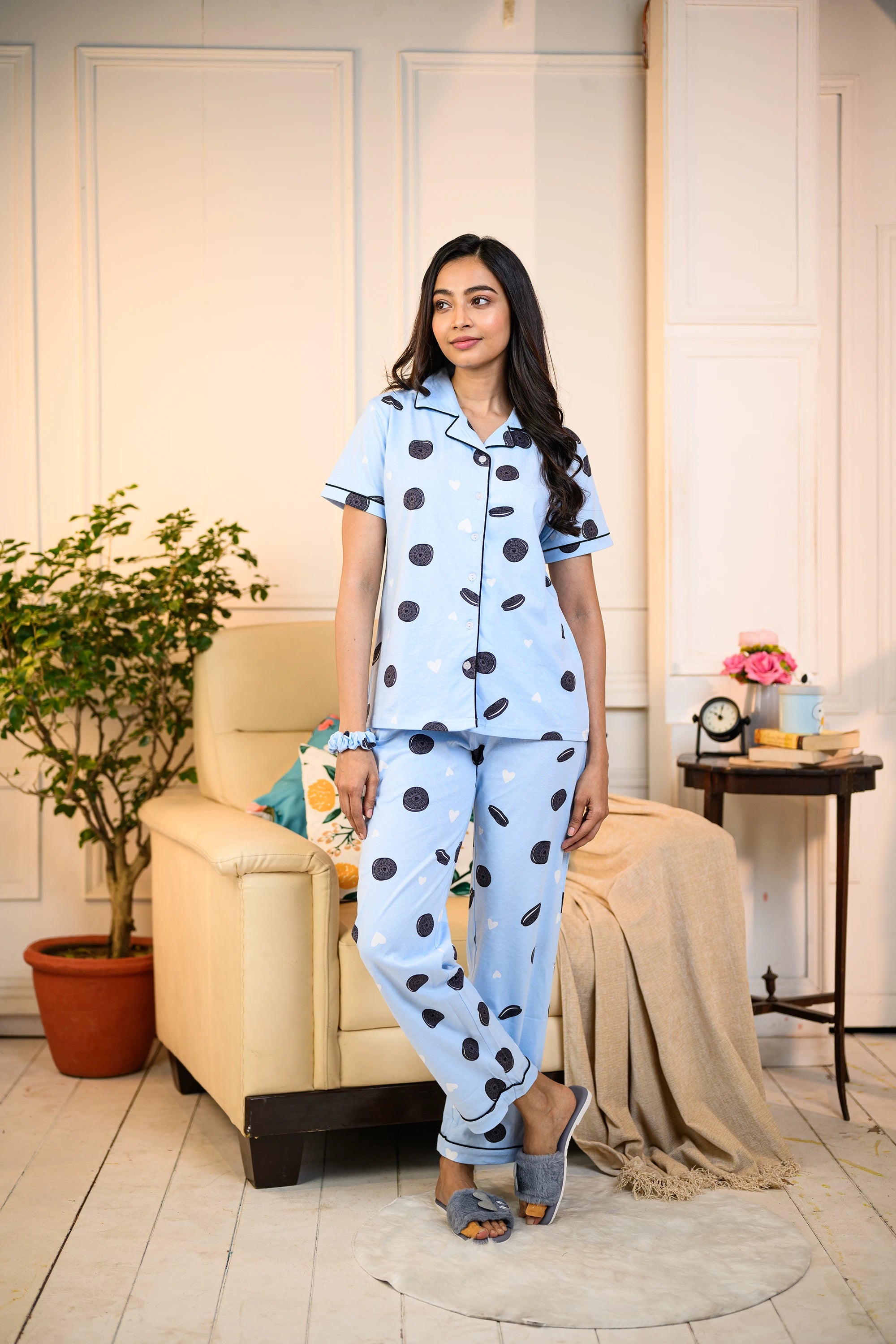 Woman standing in a blue Oreo Print Pyjama Set by NapStory, featuring playful cookie designs, styled for nightwear or lounging.