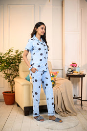 Side view of a woman wearing a blue Oreo Print Pyjama Set by NapStory, designed with a playful cookie pattern, ideal for relaxed evenings.