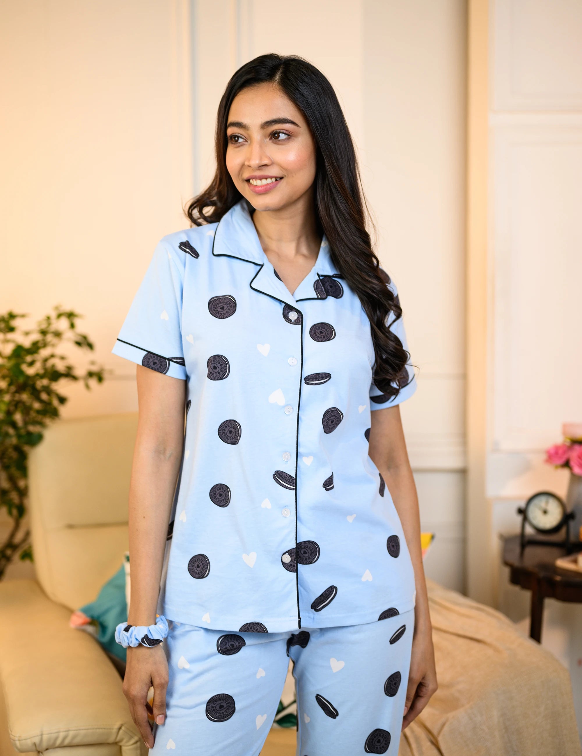 Woman wearing a blue Oreo Print Pyjama Set by NapStory, featuring playful Oreo patterns, styled for comfort and nightwear.