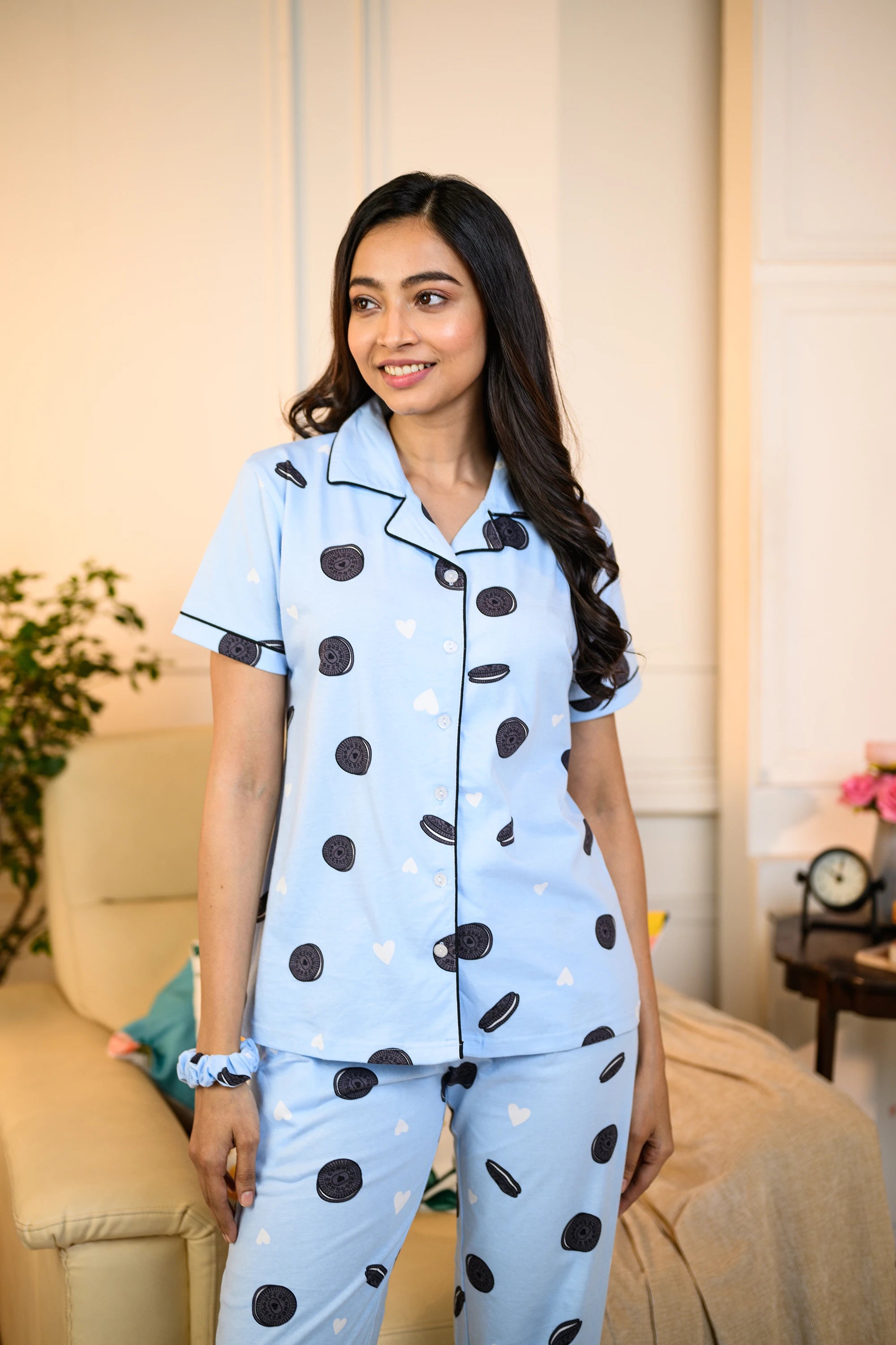 Woman wearing a blue Oreo Print Pyjama Set by NapStory, featuring playful Oreo patterns, styled for comfort and nightwear.