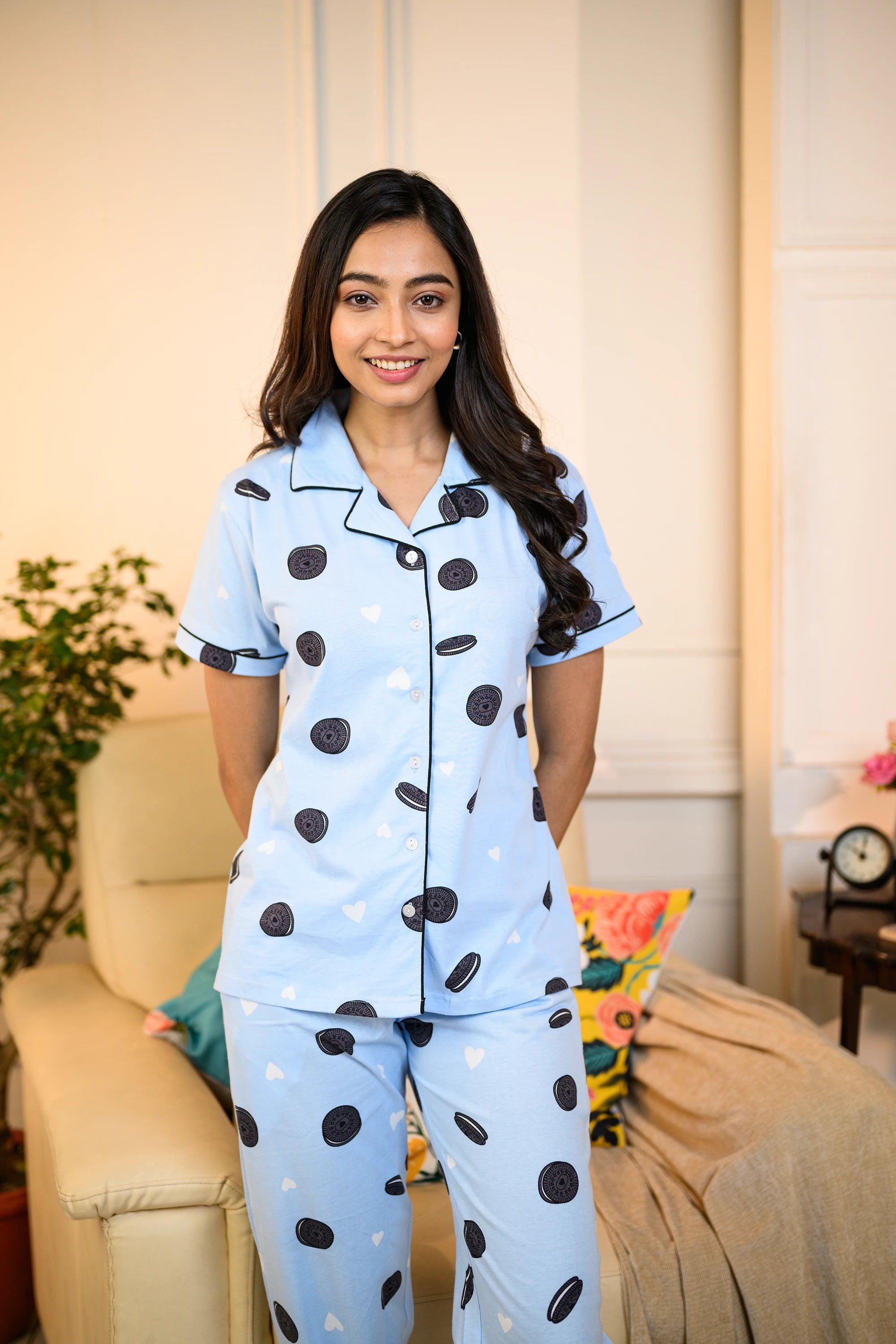 Woman wearing a blue Oreo Print Pyjama Set by NapStory, featuring playful cookie patterns, perfect for cozy nightwear.