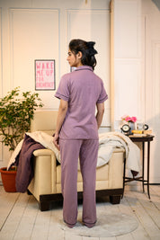 A young woman in a back pose, dressed in Dusty Lilac Solid Nightwear by NapStory.