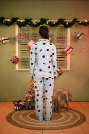 Woman standing with her back slightly turned, showing the back of an Oreo print full-sleeve pyjama set.