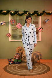 Woman standing with a relaxed pose, smiling, wearing an Oreo print full-sleeve pyjama set.