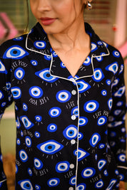 A close-up of the Evil Eye Print Full Sleeves Pyjama Set, highlighting the bold eye pattern and the phrase "I SEE YOU" on the shirt's fabric. Stylish and comfortable nightwear for women by NapStory.