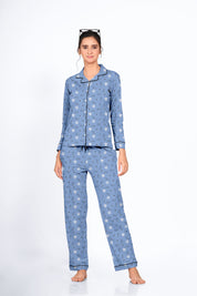 Woman in a blue Dandelion Print Full Sleeves Pyjama Set by NapStory, standing confidently with a gentle smile.