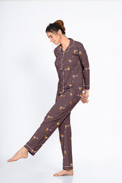 Girl in a brown Bunny Cone Print Full Sleeves Pyjama Set by NapStory, striking a playful pose with a gentle smile.