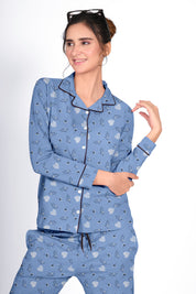 Lady in a blue Dandelion Print Full Sleeves Pyjama Set by NapStory, posing with a gentle smile and stylish look.