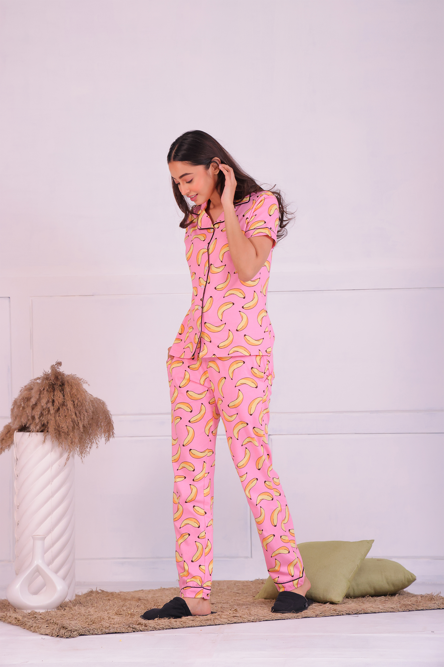 A lady in pink colour banana print nightwear pyjama set