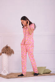 A lady in pink colour banana print nightwear pyjama set