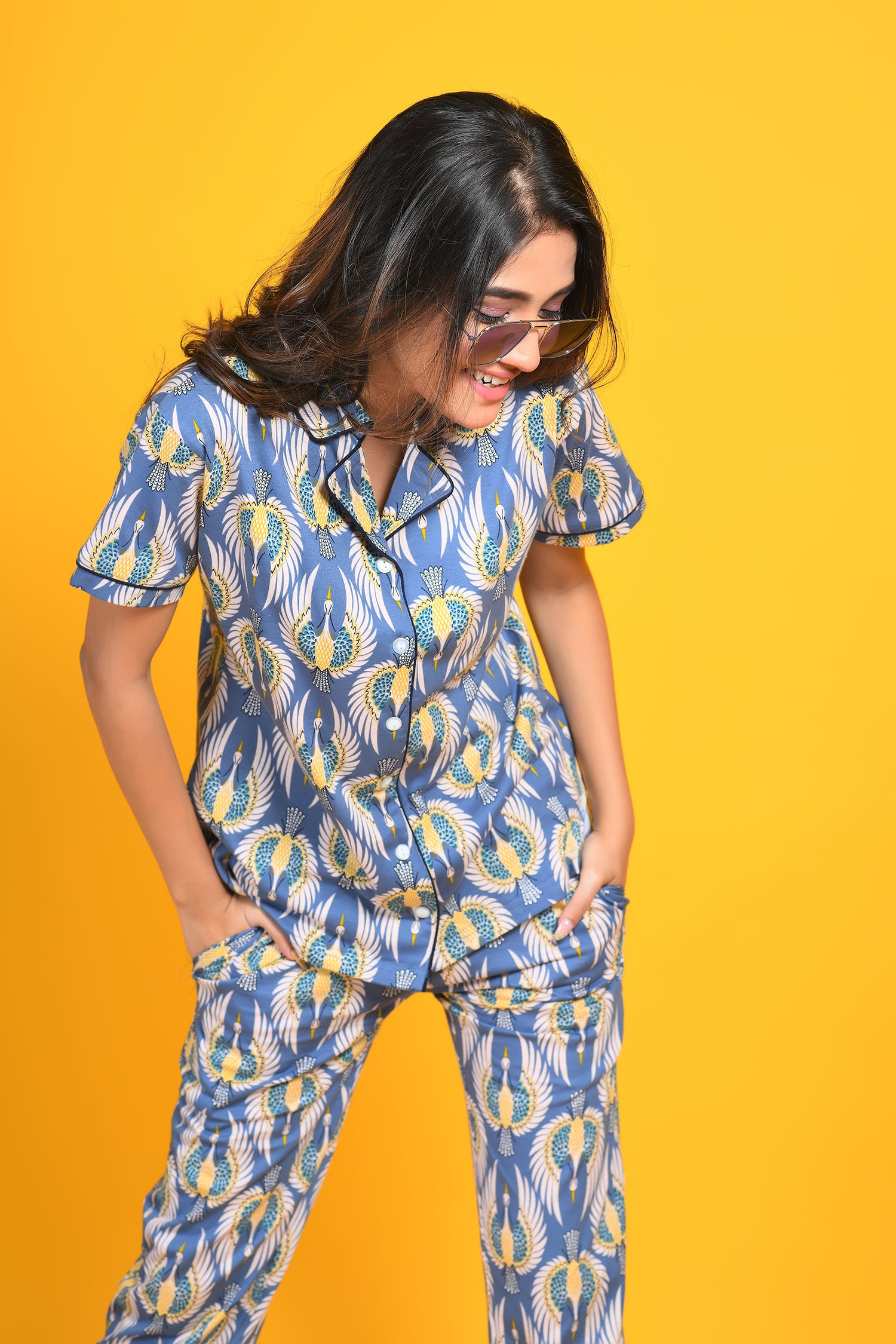 A cheerful young woman in stylish and trendy bird print night suit/ pyjama and shirt set