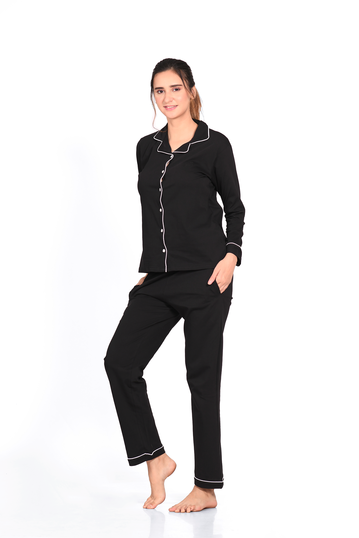 Woman showing the front view of a plain full-sleeve 100% cotton black nightsuit set by Napstory.