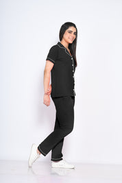 Side view of a woman in stylish and trendy solid black colour night suit/ pyjama and shirt set