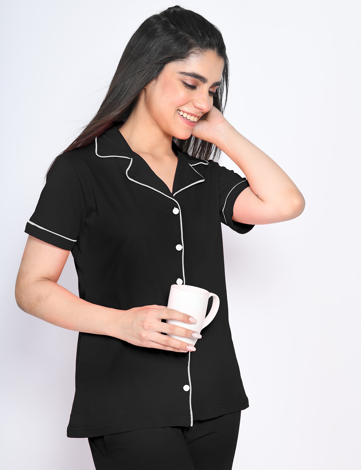 A woman in solid black colour nightwear pyjama and shirt set