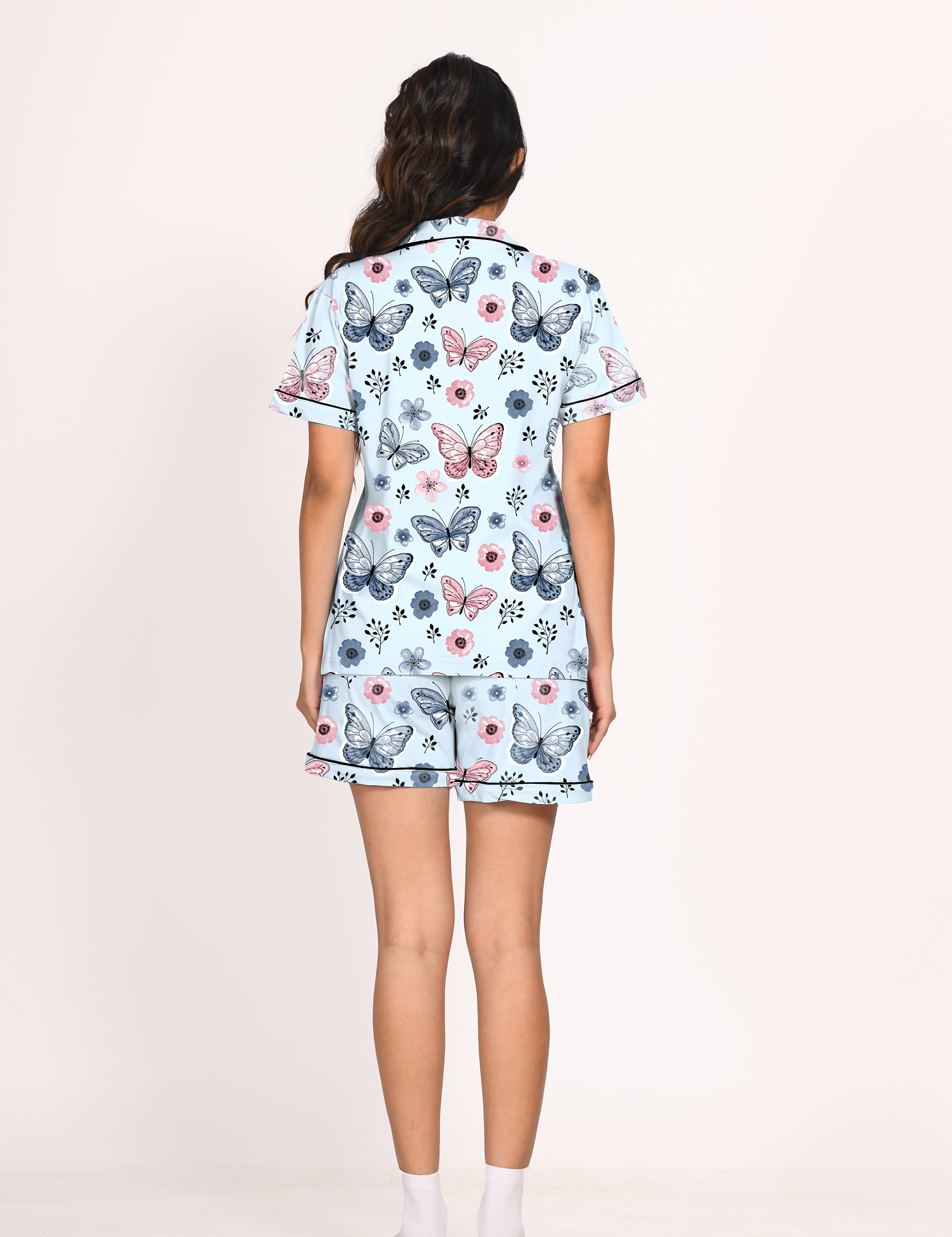 A young lady showing back view of 100% cotton Butterfly print nightwear shorts set for women by Napstory