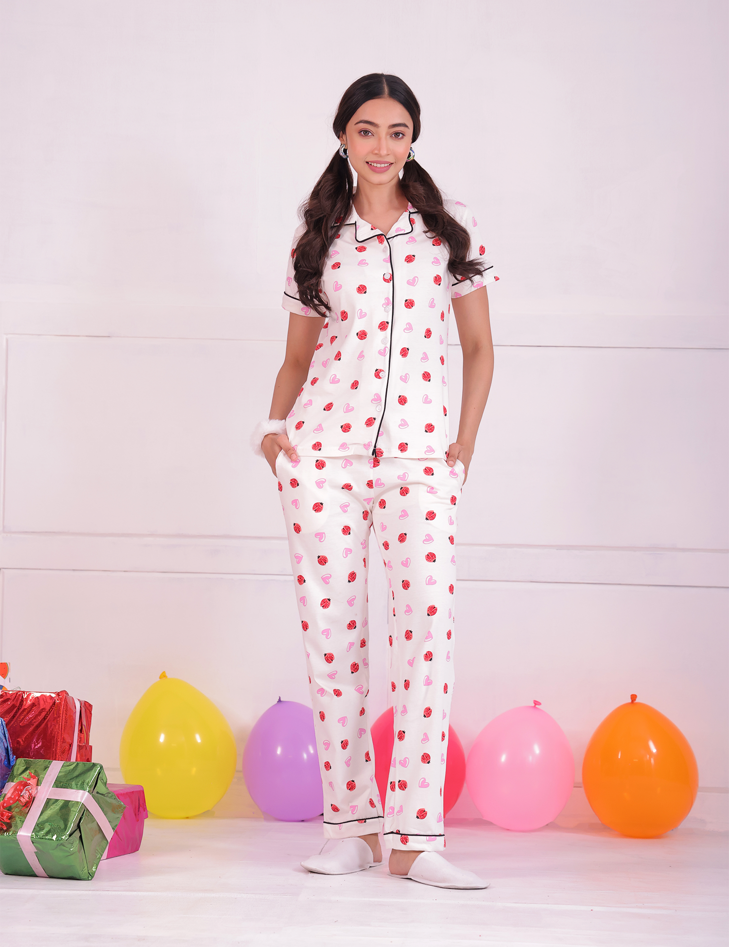 A young woman standing in Lovebug print nightwear pyjama set by NapStory