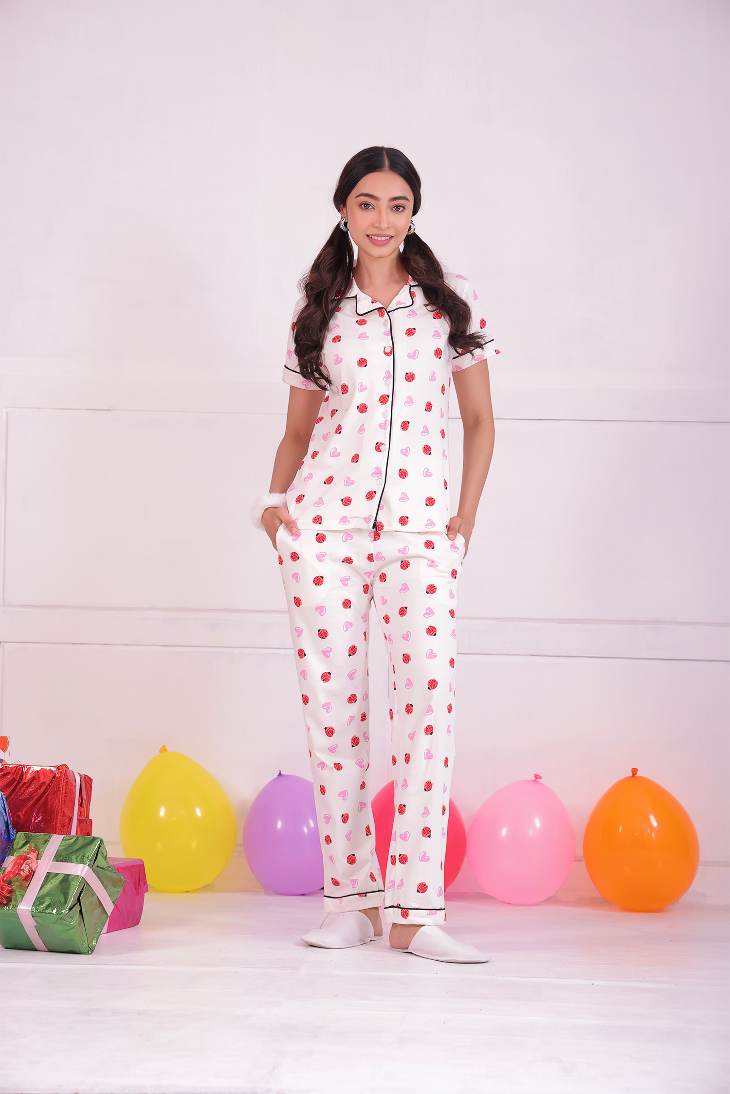 A young woman standing in Lovebug print nightwear pyjama set by NapStory