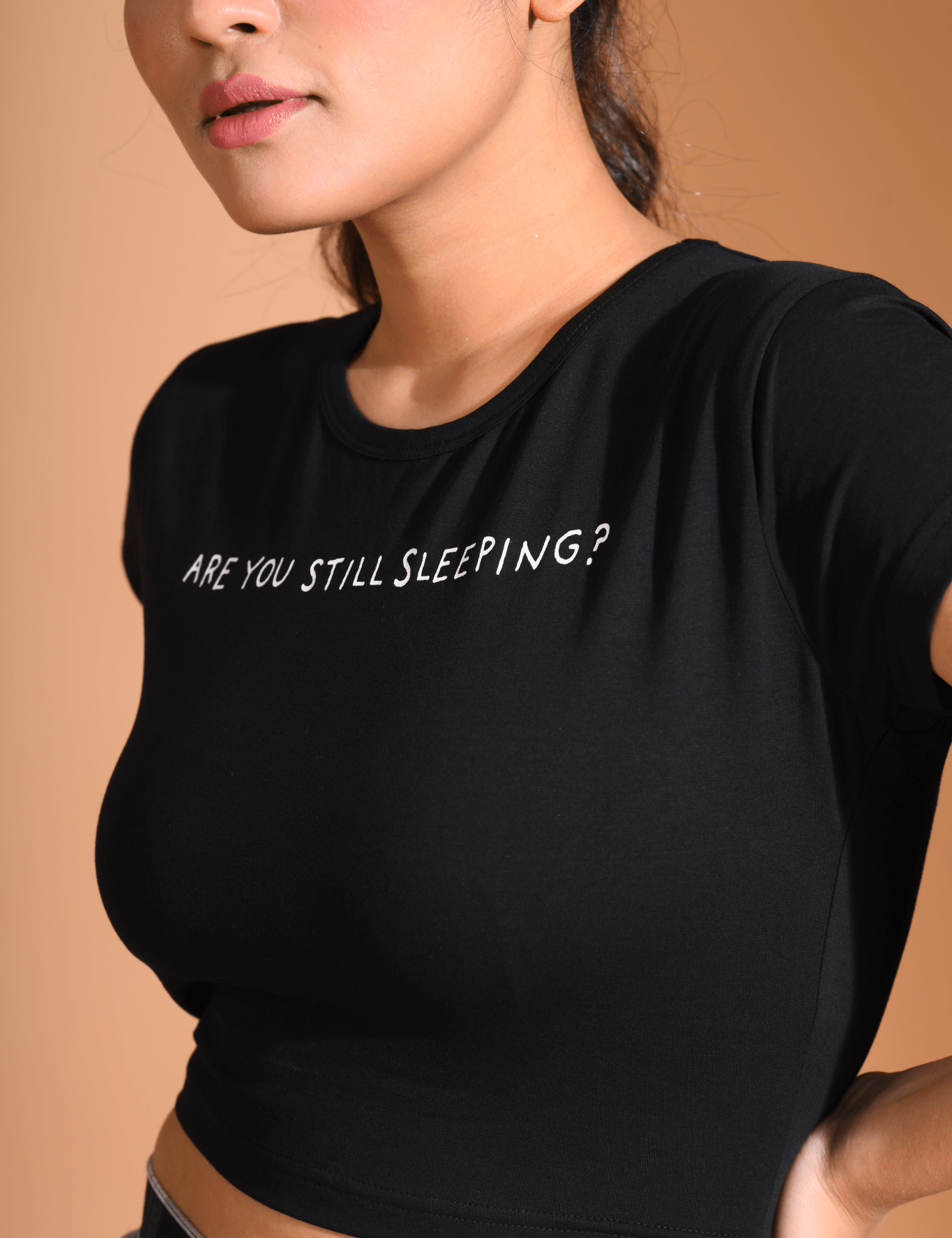 Woman posing side view in Still Sleeping Baby Tee by Napstory