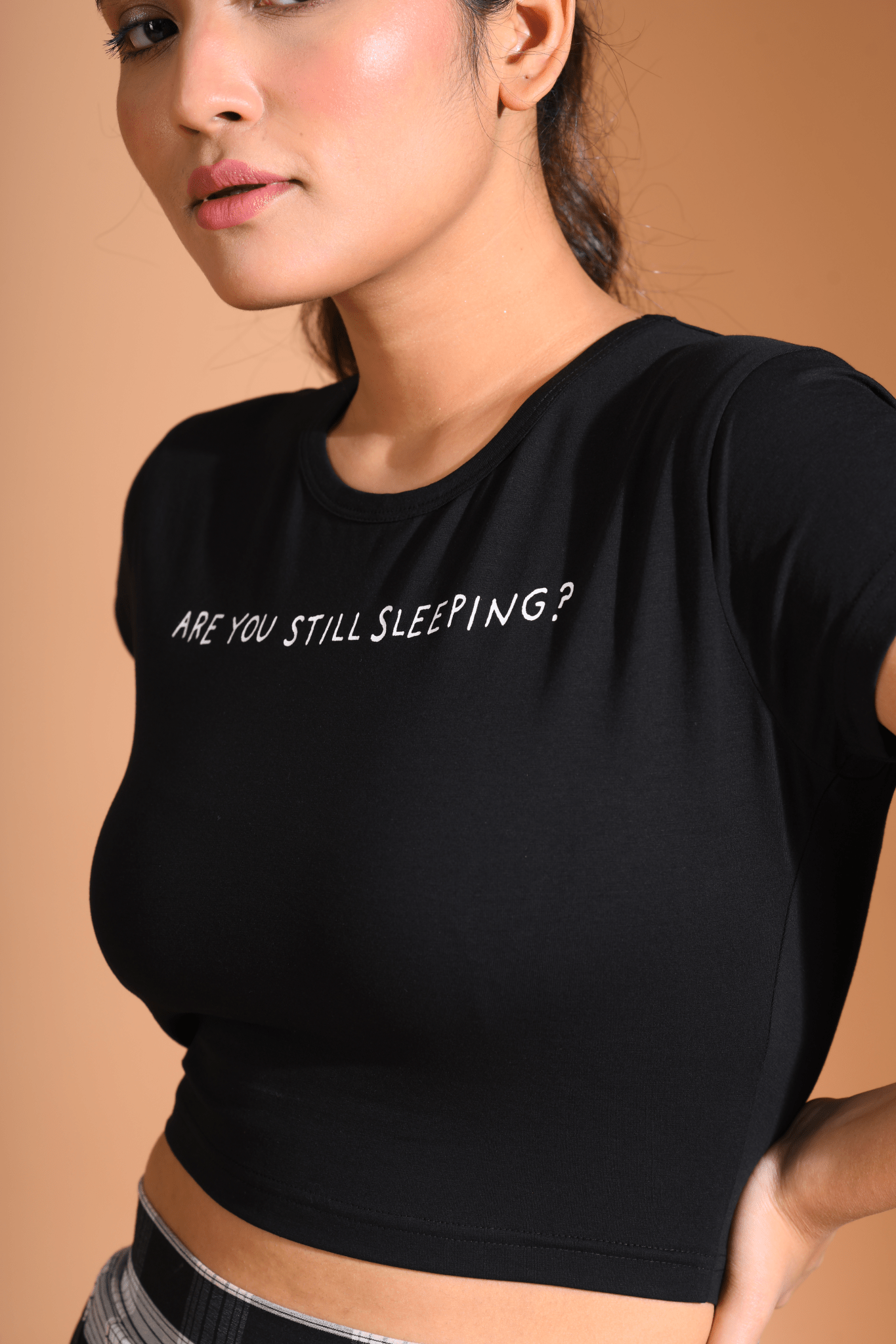 Woman posing side view in Still Sleeping Baby Tee by Napstory